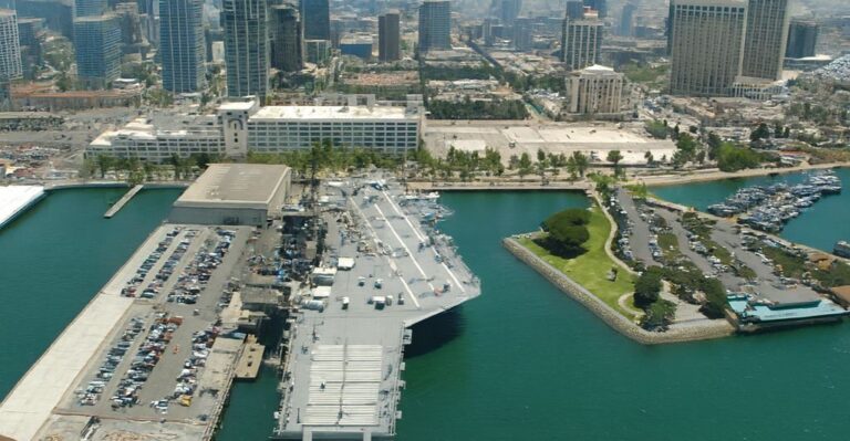 Aerial view of USS Midway Museum San Diego Bay with downtown skyline and waterfront marina