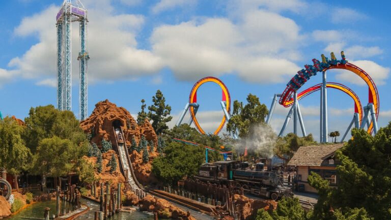 A vibrant view of SeaWorld San Diego theme park showing roller coasters, water rides, and palm trees, photographed for Richline Transportation.