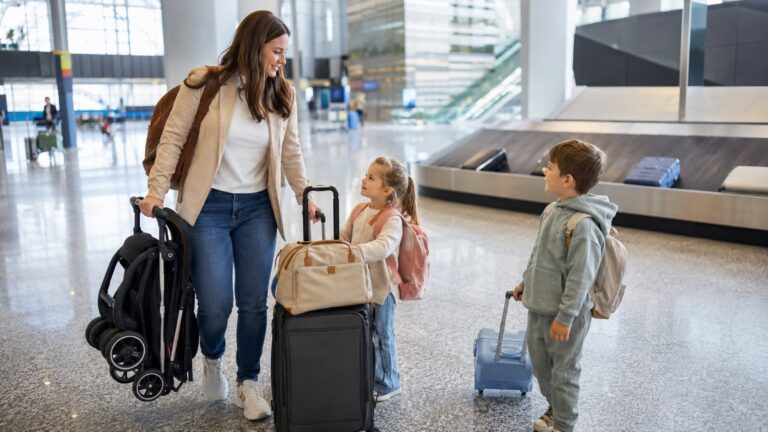 San Diego Airport With Kids family waiting at baggage claim with stroller, luggage, and children